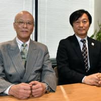 Apure Inc. President Hirosuke Takahashi (left) and NTT Docomo\'s Corporate Sales and Marketing Department Executive Director Masamichi Endou during an interview with The Japan Times in Tokyo on Jan. 18. | YOSHIAKI MIURA
