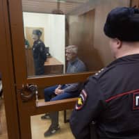 Michael Calvey, founder of private-equity firm Baring Vostok Capital Partners, sits in a security booth during a hearing at the Basmanny District Court in Moscow Feb. 16. A Russian court ruled that Calvey, one of the country\'s longest-standing American investors, should be held in custody for nearly two months in an embezzlement case. | BLOOMBERG