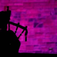 A piper plays a tune at Edinburgh Castle to herald the New Year during the Hogmanay celebrations in Edinburgh in 2018. | REUTERS