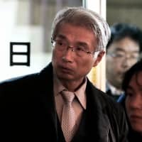 Junichiro Hironaka (left), a lawyer representing former Nissan Motor Co. Chairman Carlos Ghosn, leaves after a news conference on Wednesday. | BLOOMBERG