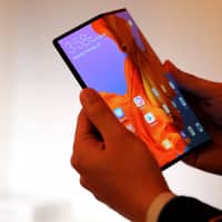 The foldable Huawei Mate X smartphone is demonstrated Saturday ahead of the Mobile World Congress in Barcelona, Spain. | REUTERS
