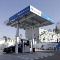 A Toyota Motor Corp.\'s Mirai fuel-cell vehicle (FCV) sits parked in a hydrogen pump station in Kawasaki, Kanagawa Prefecture, on March 30 last year. Japan aims to build hydrogen fueling stations at about 160 locations by fiscal 2020. | BLOOMBERG