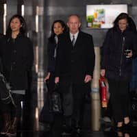 U.S. Deputy Trade Representative Jeffrey Gerrish (center) and members of his negotiation team leave a hotel ahead of a meeting with Chinese officials in Beijing on Sunday. | AFP-JIJI