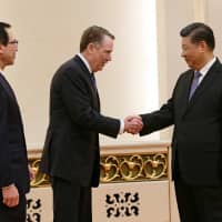 U.S. Trade Representative Robert Lighthizer shakes hands with Chinese President Xi Jinping next to U.S. Treasury Secretary Steven Mnuchin before proceeding to their meeting at the Great Hall of the People in Beijing on Friday. | REUTERS