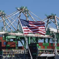 Shipping containers from China and other nations are unloaded at the Port of Long Beach in Los Angeles on Saturday. | AFP-JIJI