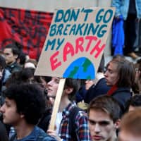 Youths call for action to halt climate change during a school strike in front of the Ecology Ministry in Paris on Friday. | REUTERS