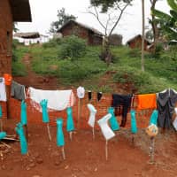 Disinfected health care workers\' gear dry in a hospital in Bwana Suri, Ituri province, Congo, in December. | REUTERS