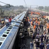 Rescue workers look for survivors after a passenger train derailed near Sahadai Buzurg railway station in the eastern state of Bihar, India, Sunday. | REUTERS