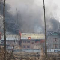 A house where suspected militants were holing up is seen in flames during a gunbattle with Indian security forces in Pinglan village in south Kashmir\'s Pulwama district Monday. | REUTERS