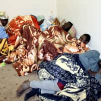 Survivor migrants who were on a boat for 12 days at sea without food or water are seen in Misrata, Libya, in December. | REUTERS