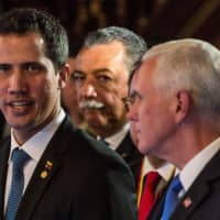 U.S. Vice President Mike Pence (right) and Venezuelan opposition leader and self-declared acting president Juan Guaido take part in a meeting with foreign ministers of the Lima Group at Colombia\'s Foreign Affairs Ministry in Bogota Monday. | AFP-JIJI