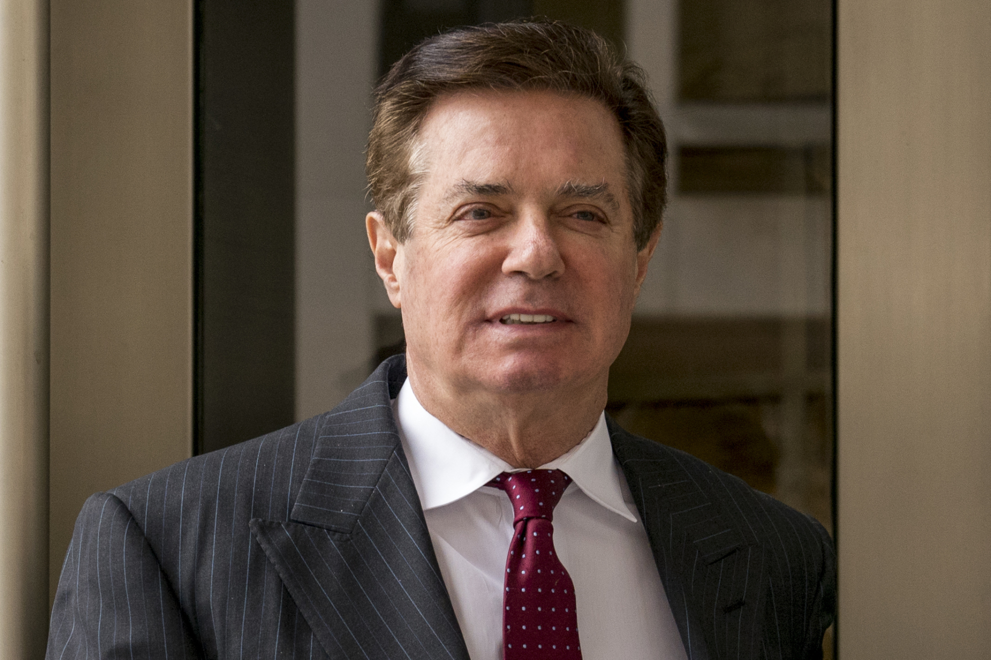 Paul Manafort, President Donald Trump's former campaign chairman, leaves the federal courthouse in Washington last April. An August 2016 meeting between Manafort and an associate with ties to Russian intelligence goes to the 'heart' of the Russia investigation. That's according to a newly unsealed court transcript in Manafort's criminal case. | AP