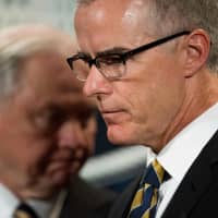 U.S. Attorney General Jeff Sessions (left) looks on as Acting Director of the Federal Bureau of Investigation Andrew McCabe speaks during a press conference at the Department of Justice in Washington in 2017. | AFP-JIJI