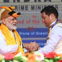 Indian Prime Minister Narendra Modi greets Arunachal Pradesh chief minister Pema Khandu at an inauguration ceremony for development projects on Saturday. | PIB / VIA AFP-JIJI