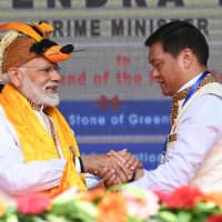 Indian Prime Minister Narendra Modi greets Arunachal Pradesh chief minister Pema Khandu at an inauguration ceremony for development projects on Saturday. | PIB / VIA AFP-JIJI