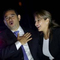 Jimmy Morales and his wife, Patricia Marroquin de Morales, celebrate with supporters after he won Guatemala\'s presidential election in Guatemala City on Oct. 26, 2015. | REUTERS