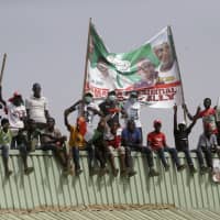 Supporters of Nigerian presidential candidate Atiku Abubakar, of the People\'s Democratic Party, attend an election campaign rally on the street in Yola, Nigeria, Thursday. Nigeria goes to the polls on Saturday to elect a new president. | AP