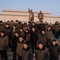 People leave after paying their respects before the statues of late North Korean leaders Kim Il Sung and Kim Jong Il as part of celebrations marking the birthday of the latter in Pyongyang on Saturday. | AFP-JIJI
