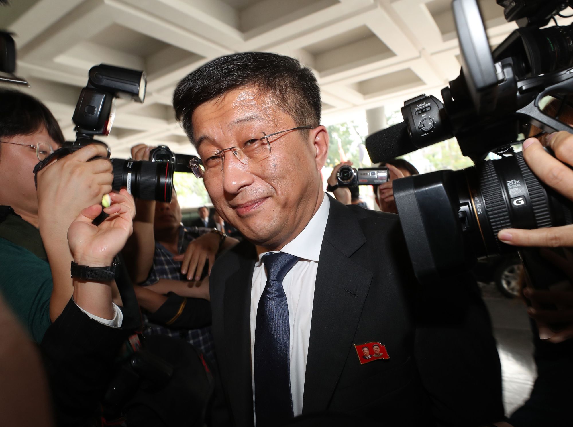 North Korea's top nuclear negotiator, Kim Hyok Chol, is surrounded by the media as he arrives for talks with U.S. counterpart Stephen Biegun in Hanoi on Thursday. | AFP-JIJI