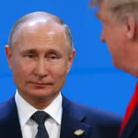 Russian President Vladimir Putin and U.S. President Donald Trump are seen during the Group of 20 summit in Buenos Aires last November. | REUTERS