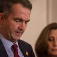 Virginia Gov. Ralph Northam, accompanied by his wife, Pamela Northam, announces he will not resign during a news conference in Richmond, Virginia, Saturday. | REUTERS