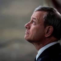 Supreme Court Chief Justice John G. Roberts waits for the arrival of former President George H.W. Bush to lie in state at the U.S. Capitol Rotunda on Dec. 3. | POOL / VIA REUTERS