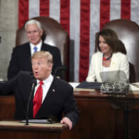 President Donald Trump acknowledges women in Congress as he delivers his State of the Union address to a joint session of Congress, as Vice President Mike Pence and Speaker of the House Nancy Pelosi watch on Tuesday. | AP