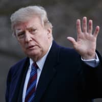 President Donald Trump waves after arriving on Marine One on the South Lawn of the White House in Washington on Friday. | AP