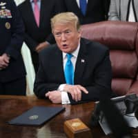U.S. President Donald Trump speaks to members of the media during a signing ceremony for Space Policy Directive 4 in the Oval Office of the White House in Washington on Tuesday. | BLOOMBERG