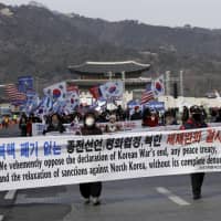 Protesters march during a rally supporting the United States\' policy to put steady pressure on North Korea, in Seoul Saturday. | AP