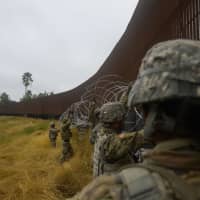 U.S. Army soldiers with the 889th Engineering Support Company lay concertina wire along the Gateway International Bridge in Brownsville, Texas, while the 89th Military Police Brigade provide security in the Department of Defense\'s support of the southwest border in Noveember. Thousands more troops will head to the U.S.-Mexico border, Acting Defense Secretary Patrick Shanahan said Thursday as part of a controversial mission to enhance security along the frontier. | ALEXANDRA MINOR / US AIR FORCE / VIA AFP-JIJI