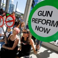 Protesters hold signs as they call for a reform of gun laws three days after the shooting at Marjory Stoneman Douglas High School, at a rally in Fort Lauderdale, Florida, on Feb. 17, 2018. | REUTERS