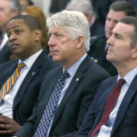 Seated in 2017 (from left) then-Virginia Lt. Governor-elect Justin Fairfax, Attorney General-elect Mark Herring and Governor-elect Ralph Northam listen as Virginia Gov. Terry McAuliffe addresses a joint meeting of the House and Senate money committees at the Pocahontas Building in Richmond. With Virginia\'s top three elected officials engulfed in scandal, fellow Democrats were rendered practically speechless, uncertain of how to thread their way through the racial and sexual allegations and their tangled political implications. | BOB BROWN / RICHMOND TIMES-DISPATCH / VIA AP