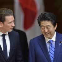 Austria\'s Chancellor Sebastian Kurz speaks with Prime Minister Shinzo Abe before reviewing a guard of honor during a welcoming ceremony before the Japan-Austria Summit meeting at the Prime Minister\'s Office in Tokyo on Friday. | AFP-JIJI