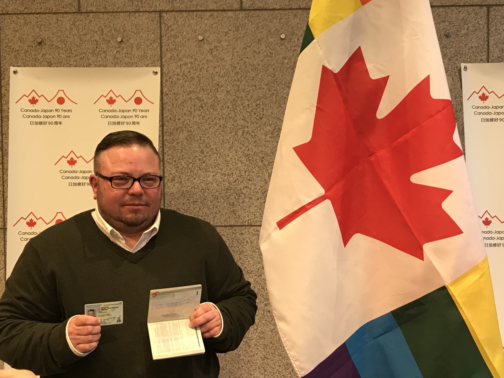 Gemma Hickey holds a driver's license and passport that designate their gender as 'X' during a media briefing at the Canadian Embassy in Tokyo on Wednesday. | CHISATO TANAKA