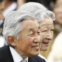 Emperor Akihito and Empress Michiko greet guests at the autumn garden party in Tokyo in November 2014. | AP