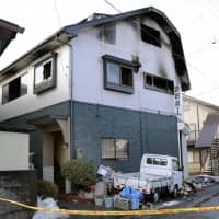 The remains of a house in Hachinohe, Aomori Prefecture, where a fire killed three people on Sunday | KYODO