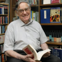 Donald Keene, the renowned scholar of Japanese literature, consults a book at his home in Kita Ward, Tokyo, in 2009. | YOSHIAKI MIURA