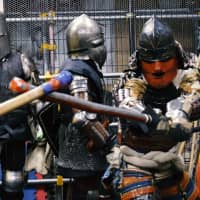 A fighter in samurai armor launches an attack during a sparring session on Feb. 10 at Castle Tintagel in Tokyo\'s Mejiro district. | CHISATO TANAKA