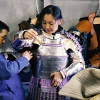 Atsushi Kasahara helps his sparring partner, Mineko Nasu, into armor that he made.  chisato tanakaA man helps his sparring partner into samurai armor at Castle Tintagel in Tokyo\'s Mejiro district on Feb. 10. | CHISATO TANAKA