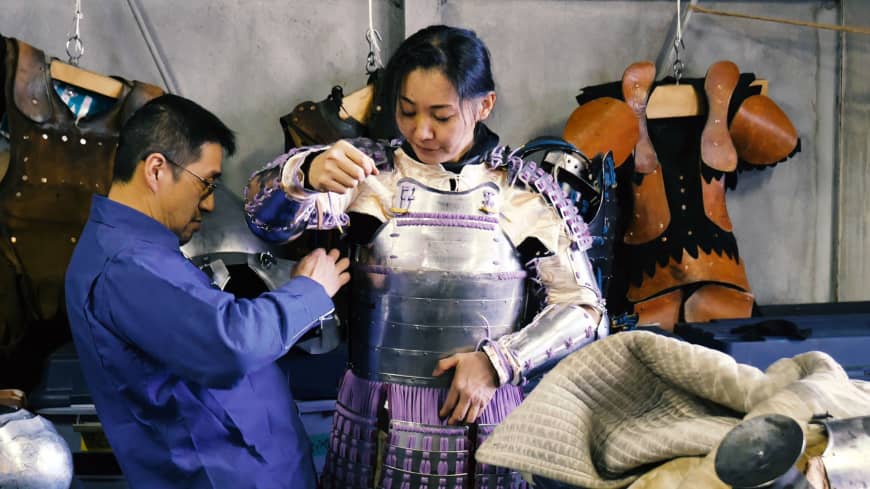Atsushi Kasahara helps his sparring partner, Mineko Nasu, into armor that he made. chisato tanakaA man helps his sparring partner into samurai armor at Castle Tintagel in Tokyo