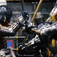 A fighter in samurai armor spars with an opponent dressed in the armor of a medieval European knight on Feb. 10 at Castle Tintagel, a medieval martial arts school in Tokyo\'s Mejiro district. | CHISATO TANAKA