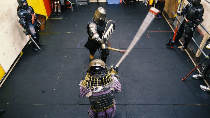 Armored fighters exchange blows with swords during a sparring session at Castle Tintagel in Tokyo