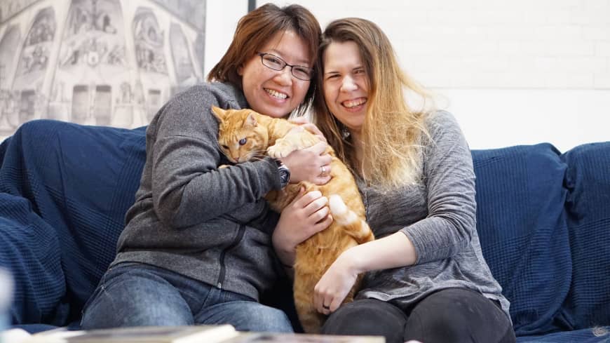 Ai Nakajima (left) and her partner, Kristina Baumann, pose at their home in Yokohama on Monday. The couple is planning to file a lawsuit in a bid to have their marriage recognized in Japan.