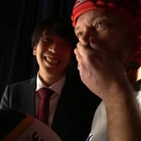 Japan Times reporter Andrew McKirdy prepares to perform with his partner, Ryuichiro Nagayama, at a manzai comedy event called Omoro Shokudo at Asagaya Art Space Plot in Tokyo in January. | CHISATO TANAKA