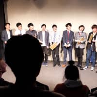 Comedians joke around on stage after the Omoro Shokudo show in Asagaya in January. | CHISATO TANAKA