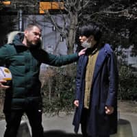 Japan Times reporter Andrew McKirdy practises with his partner, Ryuichiro Nagayama, in a park near Asagaya Art Space Plot before their performance in January. | CHISATO TANAKA