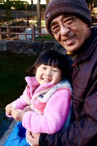Bonding with the local wildlife: Kikutaro Toku, 73, and his granddaughter Die Kashima, 3, feed the ducks in Togoshi Park.