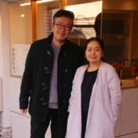 Tongue-in-cheek: Ririri Otsuka and her husband, architect Yohei Hayashiguchi, in front of their Togoshi cafe, Spread It. | KIT NAGAMURA
