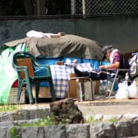 Displaced: A homeless man camps out in Ueno Park in northeastern Tokyo. | JAMES ABBOTT / CC BY-SA 2.0